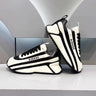 Black and white striped arch support athletic shoes