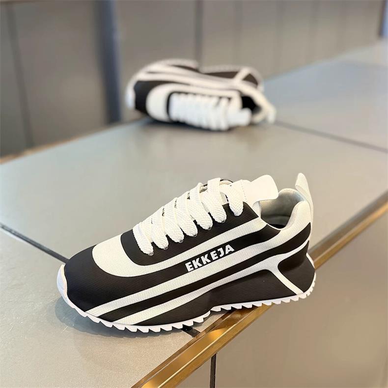 Black and white striped arch support athletic shoes